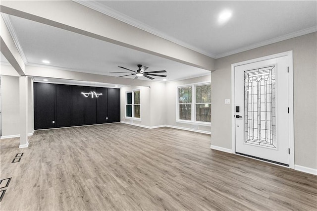 foyer featuring ceiling fan, crown molding, and wood-type flooring