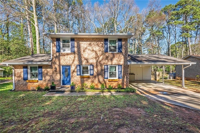 view of front of property featuring a carport, a front lawn, concrete driveway, and brick siding