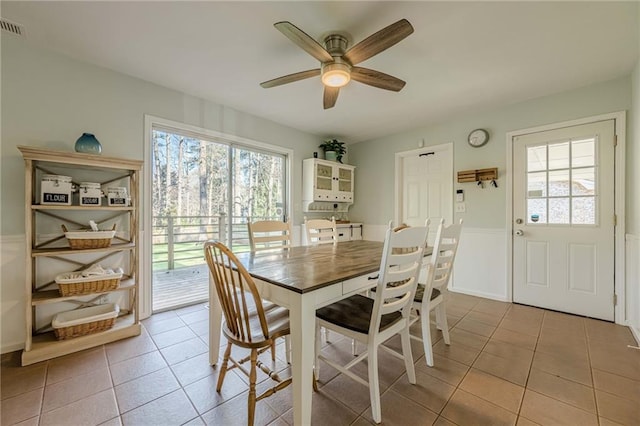 tiled dining area with visible vents and ceiling fan