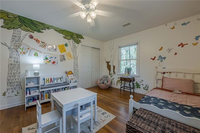 bedroom with a closet, visible vents, a ceiling fan, and wood-type flooring