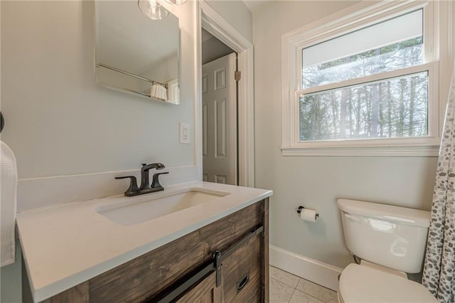 full bathroom featuring baseboards, toilet, vanity, and tile patterned flooring