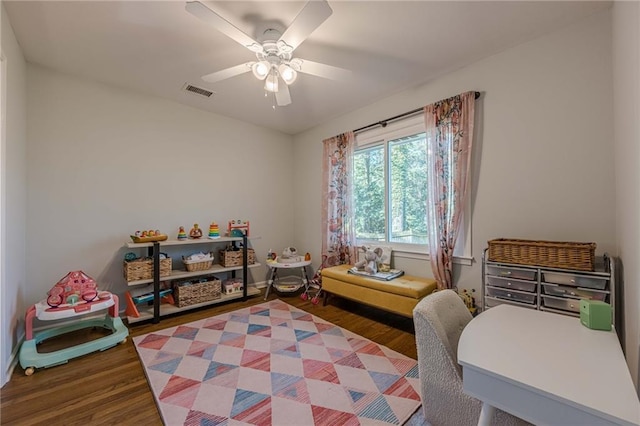 rec room with visible vents, a ceiling fan, and wood finished floors