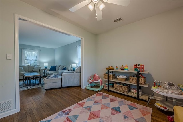 playroom featuring visible vents, baseboards, a ceiling fan, and wood-type flooring