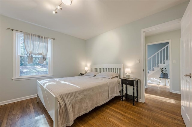 bedroom featuring dark wood-type flooring and baseboards