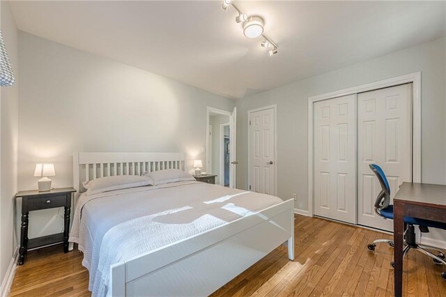 bedroom with baseboards and light wood-type flooring