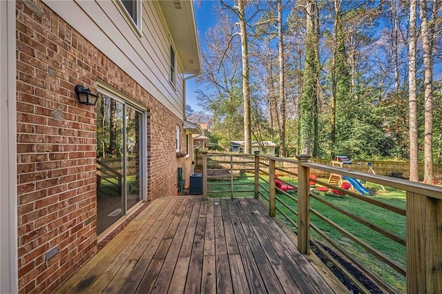 wooden terrace featuring a yard and fence