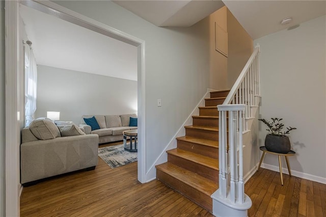 stairs featuring baseboards and wood finished floors