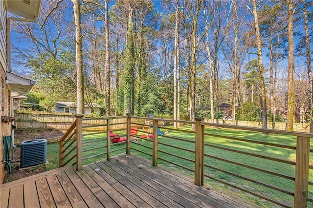 deck featuring a lawn, cooling unit, and fence