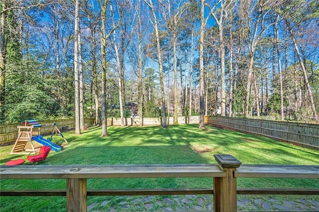 view of yard with a playground and a fenced backyard