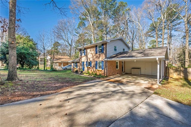 view of front of home featuring an attached carport, brick siding, concrete driveway, and fence