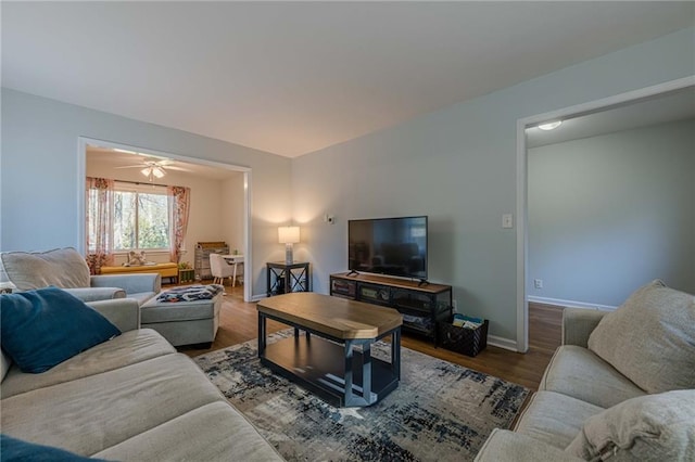 living room with baseboards and wood finished floors