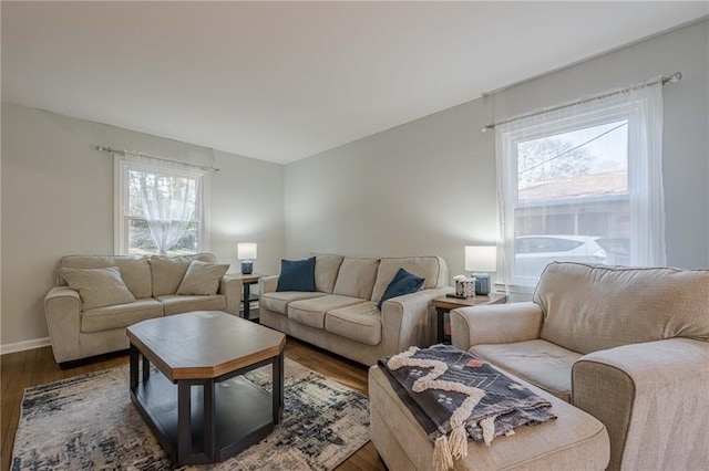 living room with baseboards and dark wood-style flooring