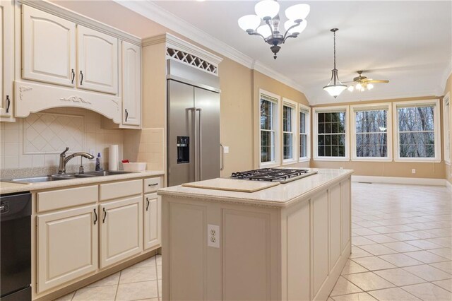 kitchen featuring ornamental molding, appliances with stainless steel finishes, white cabinets, and decorative backsplash