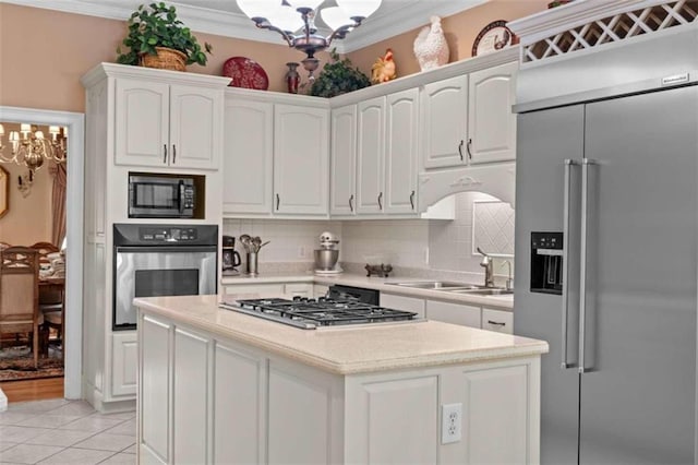 kitchen featuring white cabinetry, appliances with stainless steel finishes, a chandelier, and light tile patterned flooring