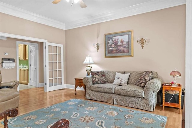 living room with ceiling fan, ornamental molding, and hardwood / wood-style floors