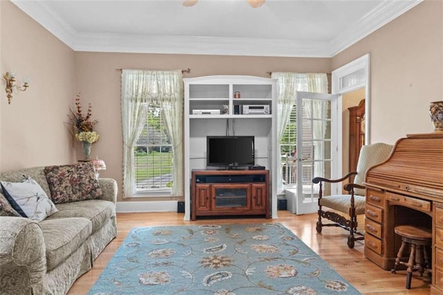 living room with light wood-type flooring and crown molding