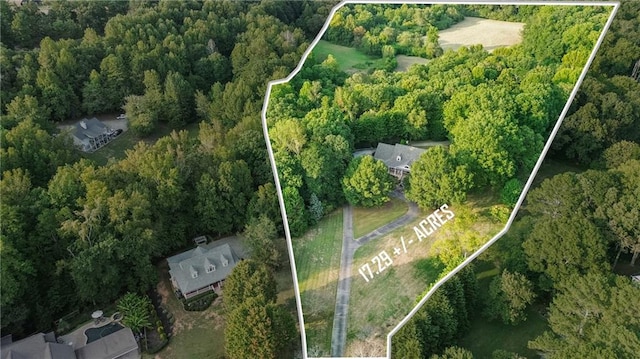 drone / aerial view with a wooded view