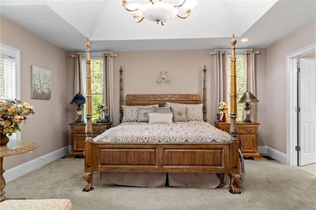 bedroom with light colored carpet, a notable chandelier, and vaulted ceiling