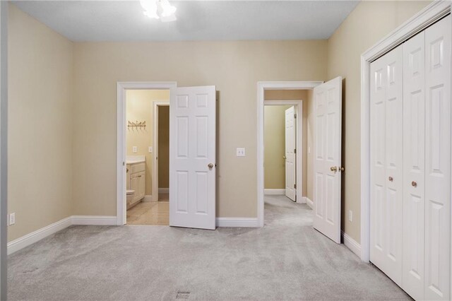 bedroom with light colored carpet and an inviting chandelier