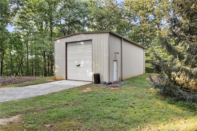 view of outbuilding with a yard and a garage