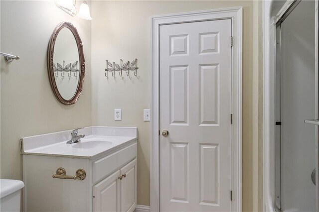 bathroom featuring tile patterned flooring, toilet, crown molding, and vanity