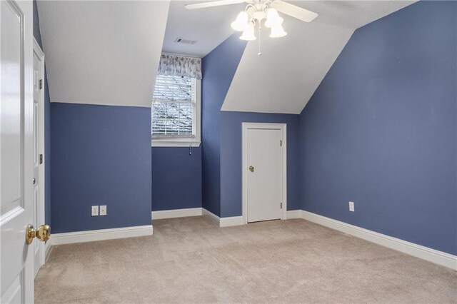 hallway with light carpet, crown molding, and lofted ceiling