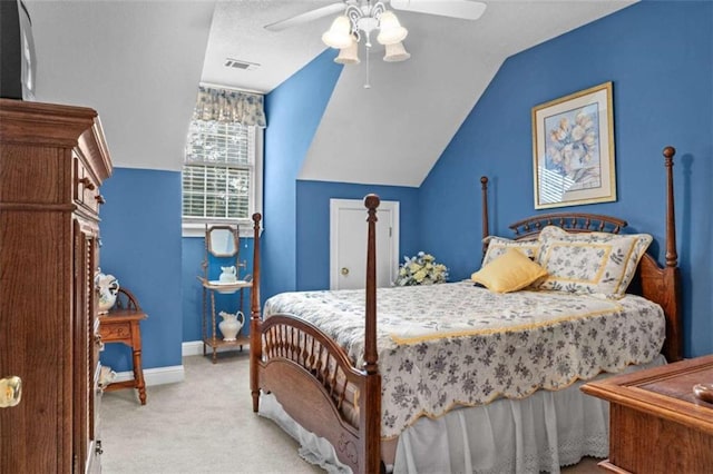 bedroom with lofted ceiling, ceiling fan, and light carpet