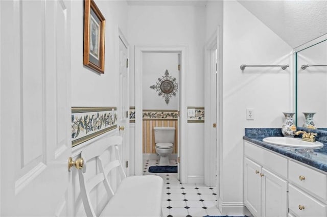 bathroom featuring vanity and toilet