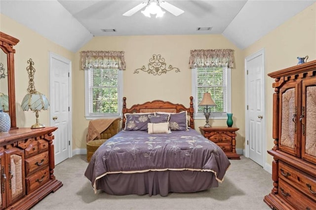 carpeted bedroom with lofted ceiling, ceiling fan, and multiple windows