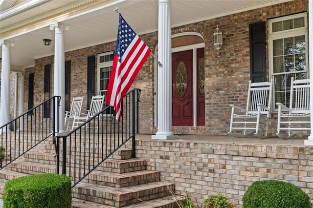 view of exterior entry featuring a porch