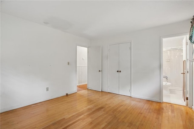 1960 Oak Leaf Ct SW, Marietta, GA 30008 - unfurnished bedroom with light wood finished floors, baseboards, a closet, and ensuite bath