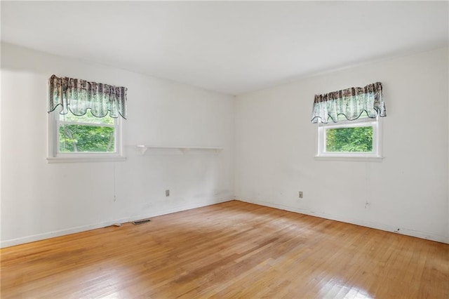 1960 Oak Leaf Ct SW, Marietta, GA 30008 - spare room with healthy amount of natural light, light wood finished floors, and baseboards
