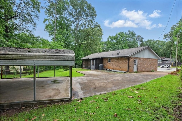 1960 Oak Leaf Ct SW, Marietta, GA 30008 - rear view of house with a lawn, brick siding, and a detached carport
