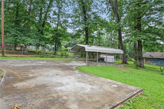 1960 Oak Leaf Ct SW, Marietta, GA 30008 - view of yard with a detached carport, driveway, and view of scattered trees