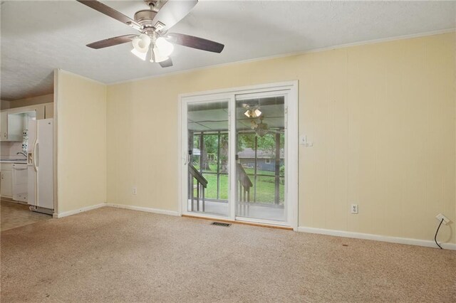 1960 Oak Leaf Ct SW, Marietta, GA 30008 - spare room featuring light carpet, crown molding, baseboards, a ceiling fan, and a sink