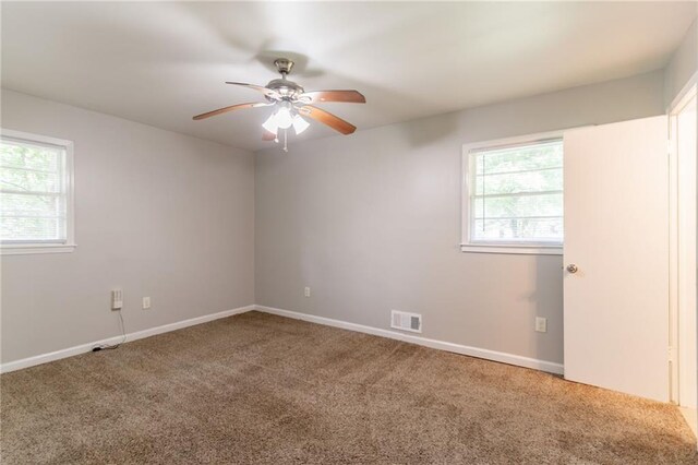 4078 Bouldercrest Rd, Ellenwood, GA 30294 - empty room featuring ceiling fan, carpet, healthy amount of natural light, and baseboards