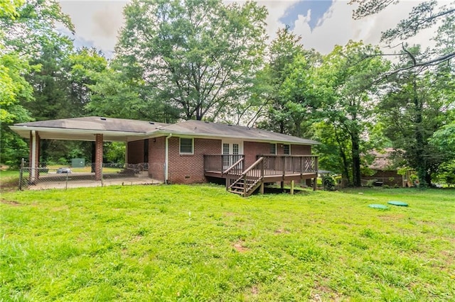 4078 Bouldercrest Rd, Ellenwood, GA 30294 - rear view of house with a deck, an attached carport, brick siding, and a yard