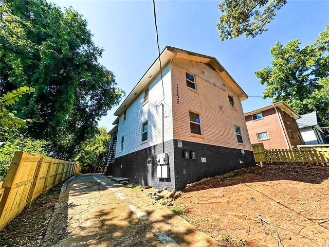 1152 Greenwich St SW, Atlanta, GA 30310 - view of side of home with brick siding and fence