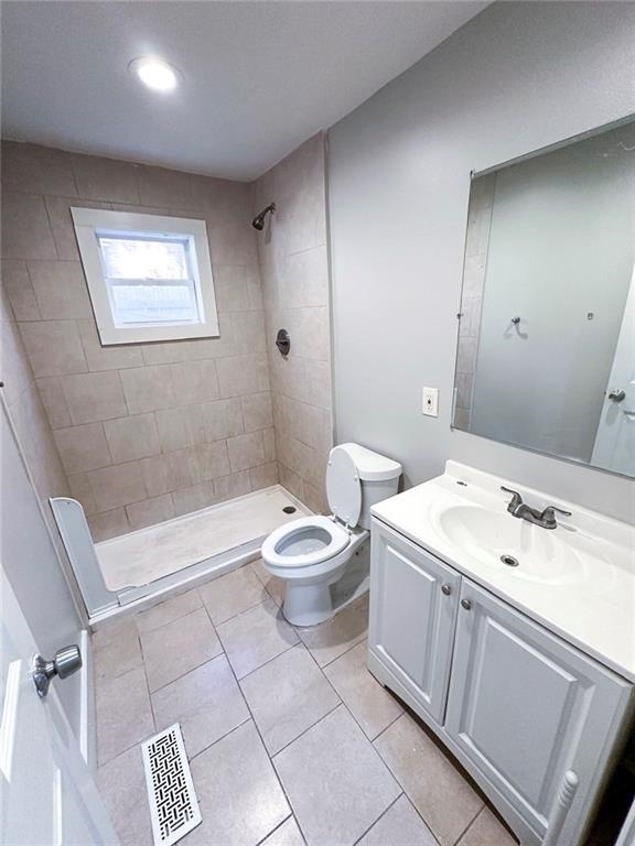 1152 Greenwich St SW, Atlanta, GA 30310 - full bath with vanity, visible vents, tile patterned flooring, a shower stall, and toilet