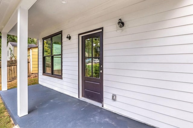 view of exterior entry with a patio area