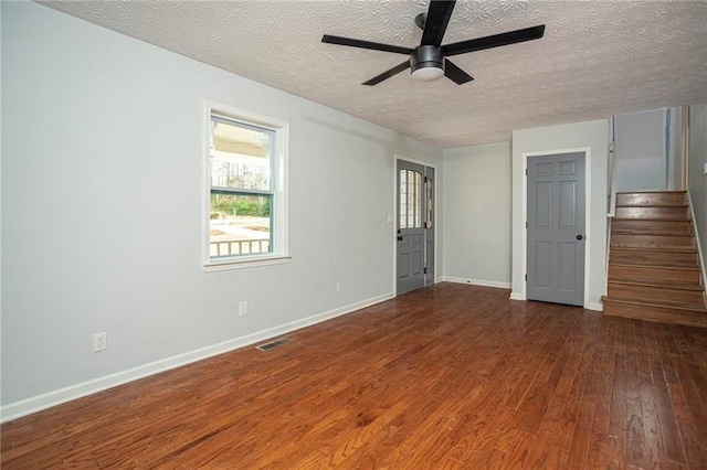 unfurnished bedroom with wood-type flooring, visible vents, a textured ceiling, and baseboards