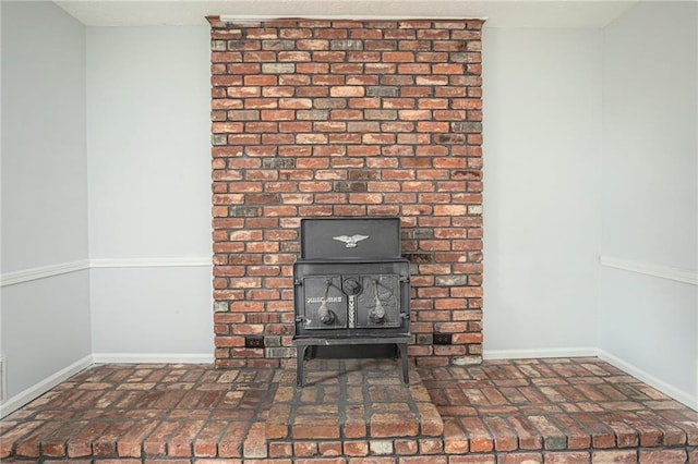 interior details with a wood stove and baseboards