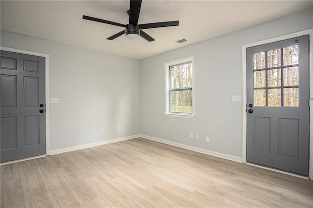 foyer with light wood-style flooring, visible vents, baseboards, and a ceiling fan