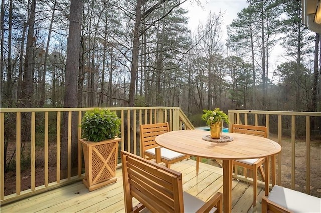 wooden terrace with outdoor dining area