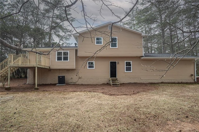 back of property featuring entry steps, a deck, and central AC