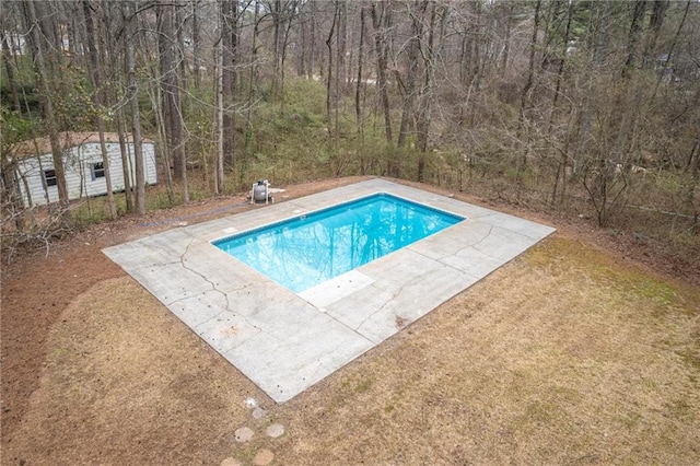 pool featuring a patio area and an outdoor structure