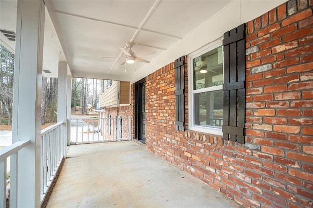 unfurnished sunroom with a ceiling fan