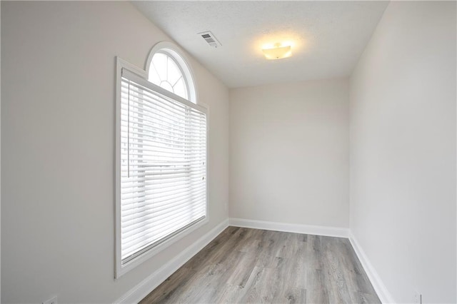 2682 Field Spring Dr, Lithonia, GA 30058 - unfurnished room featuring wood finished floors, baseboards, and a textured ceiling