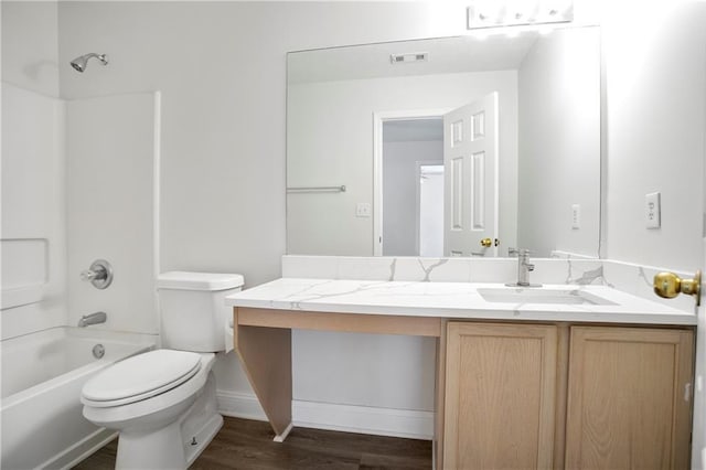 2682 Field Spring Dr, Lithonia, GA 30058 - full bathroom with vanity, toilet, washtub / shower combination, wood finished floors, and baseboards