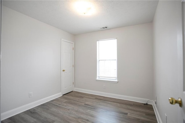 2682 Field Spring Dr, Lithonia, GA 30058 - spare room with wood finished floors, baseboards, and a textured ceiling